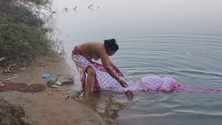 Indian village wife bathing in the river in outdoor area