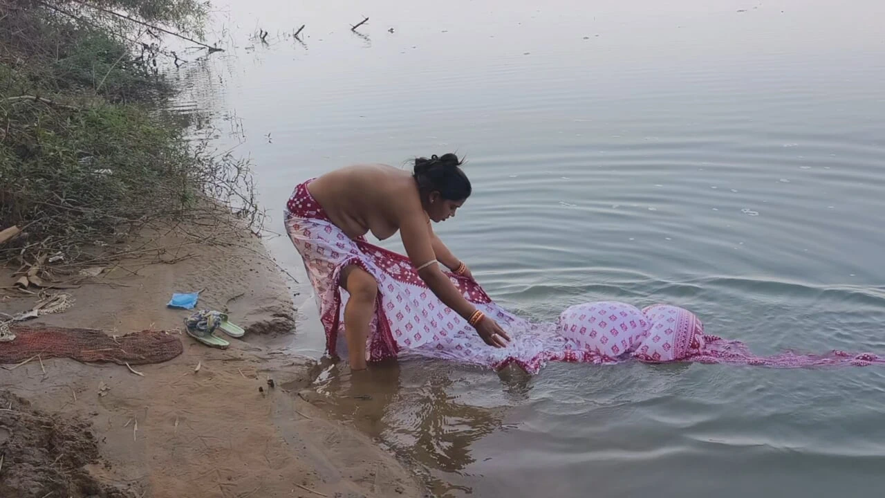 Indian village wife bathing in the river in outdoor area